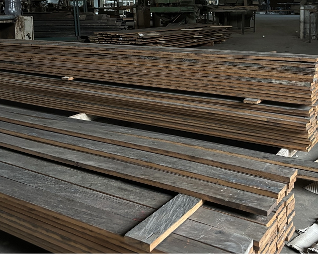 Bundles of reclaimed Ulin ironwood planks stacked in a timber warehouse